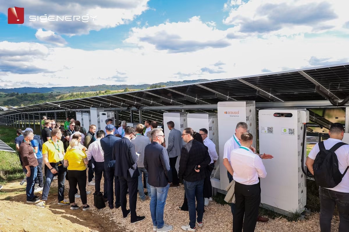 Visitors viewing SigenStack battery towers at a solar farm open day
