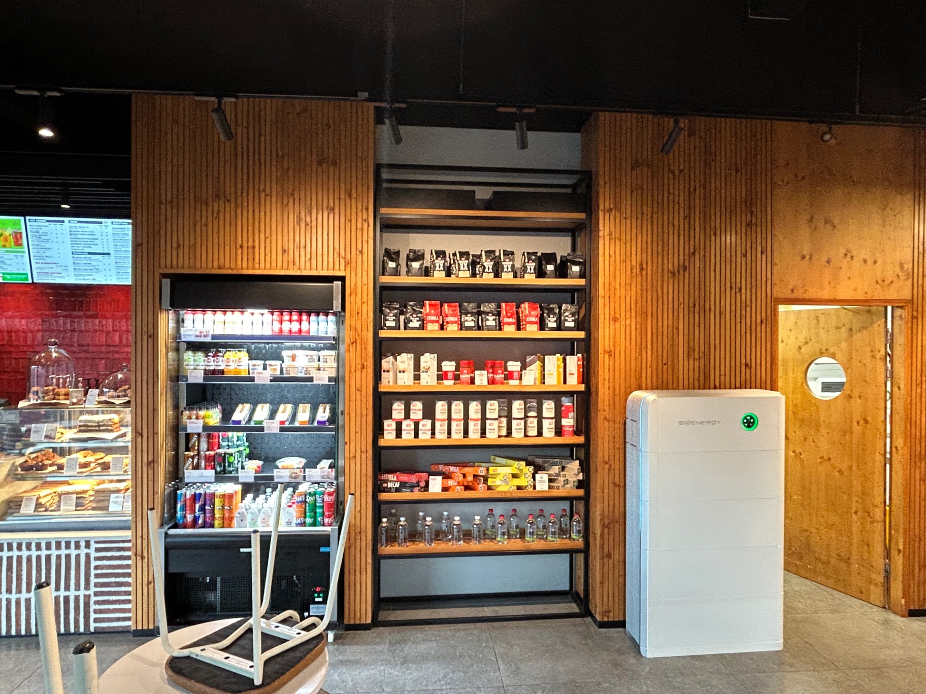 SIGENERGY all-in-one solar unit installed inside a café beside the shelving